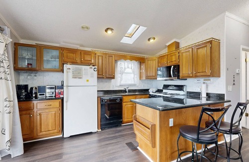 Assateague Pointe House | Coastal living with on-site pool, playground, grills, central AC, & washer/dryer
