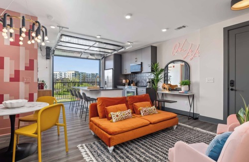 Rolling Mill Hill Apartment | Summer rooftop deck, skyline views, garage-door kitchen near Broadway