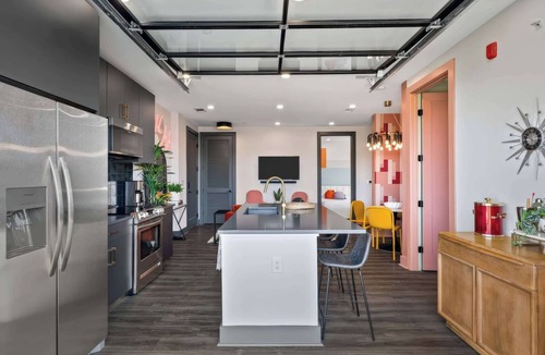 Rolling Mill Hill Apartment | Summer rooftop deck, skyline views, garage-door kitchen near Broadway