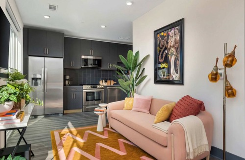 Rolling Mill Hill Apartment | Summer rooftop deck, skyline views, glass garage door near Broadway