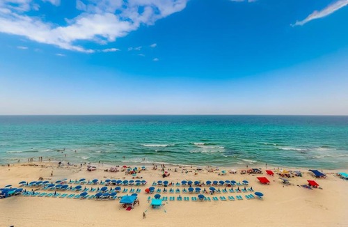 Miramar Beach House | Sunny oceanfront condo with two shared pools hot tub - walk to the beach