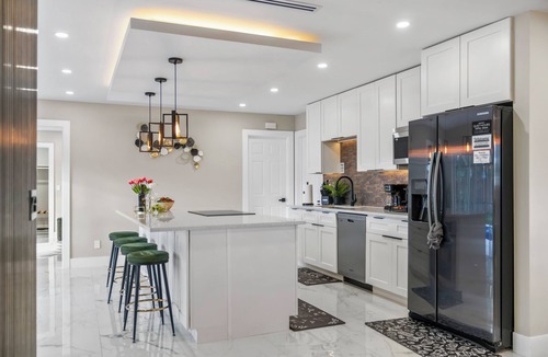 West Palm Beach Villa | Tropical Luxe Oasis with warm Pool,5 bedr 3 bath& Mini Golf, Impact Windows
