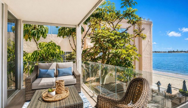 Bay-view 2BR condo in Crown Point with pool, patio, and beach access.