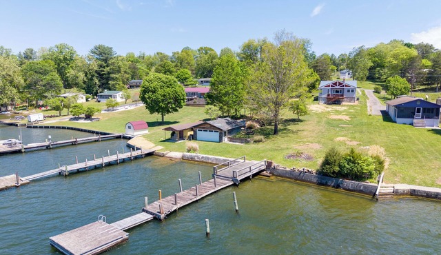 Lakefront Radford retreat with private dock, deck dining, Samsung Smart TV, and cozy queen bedrooms.