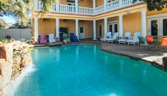 This 4/4 Villa with wrap around porch has amazing views and sits on a private canal!