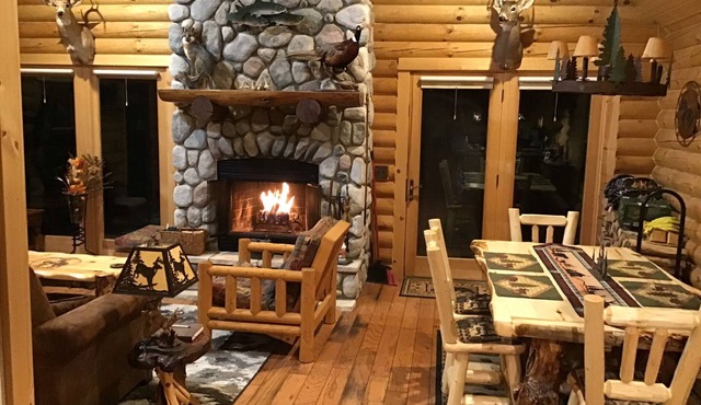 Welcome snowmobilers and skiers to a cozy log cabin on the Rapid River.